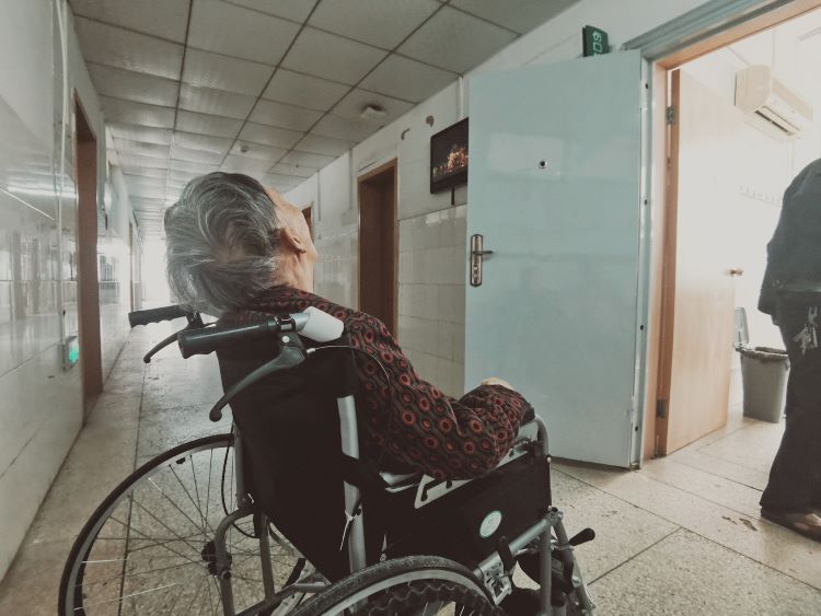 Person in a wheelchair suffering from the impact of alcoholism on the elderly