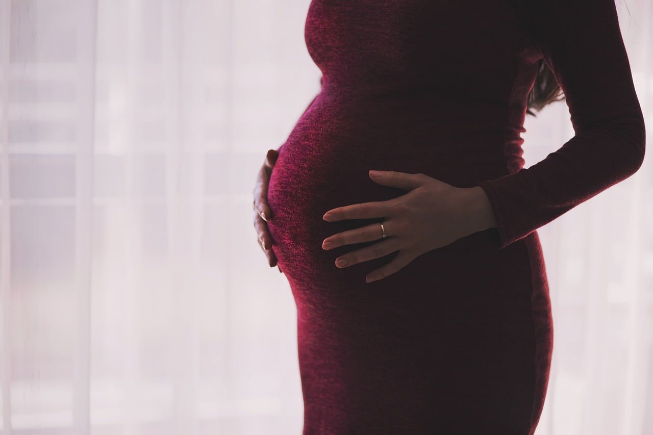 Pregnant woman thinking about binge drinking