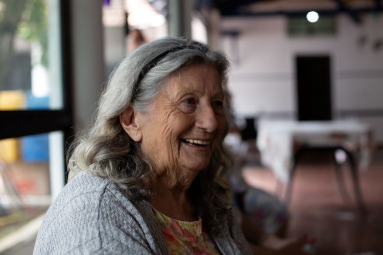 Smiling older woman receiving help for alcoholism